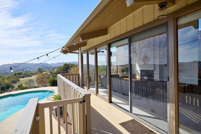 view of swimming pool with a fenced in pool and a mountain view