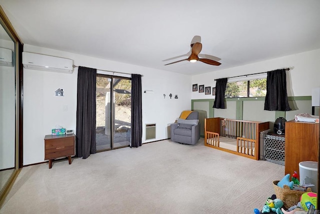 sitting room with carpet floors, a wall mounted air conditioner, and a wealth of natural light