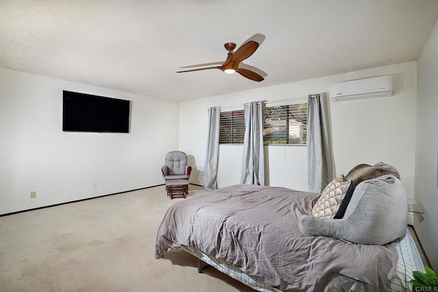 carpeted bedroom featuring ceiling fan, a textured ceiling, a wall mounted air conditioner, and baseboards