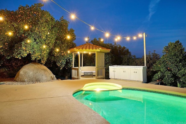 41850 Via Del Gavilan, Fallbrook, CA 92028 - pool at night featuring a gazebo, a pool with connected hot tub, and a patio