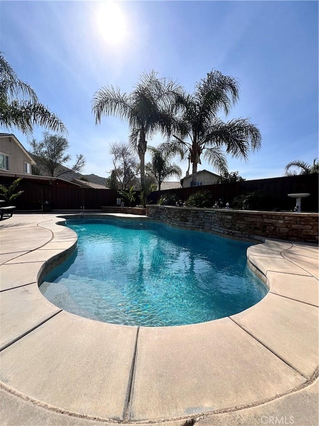 view of swimming pool with fence, a fenced in pool, and a patio