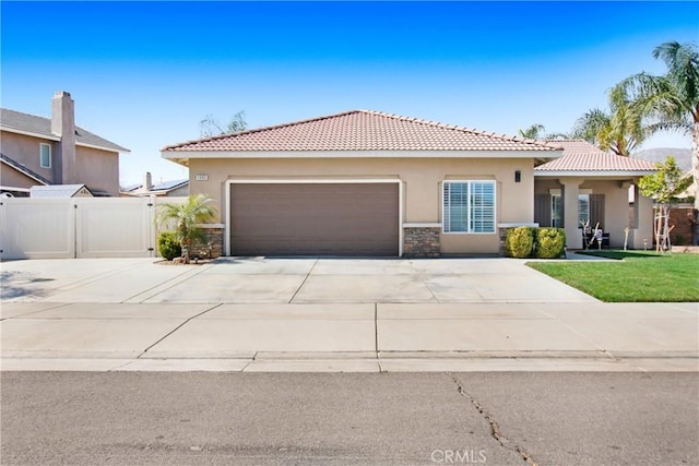 view of front of property with a garage, driveway, a front lawn, and stucco siding