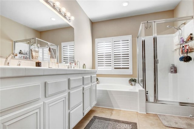 full bath with a garden tub, double vanity, recessed lighting, a stall shower, and tile patterned floors