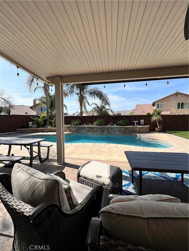 view of pool featuring a fenced in pool, a patio area, and a fenced backyard