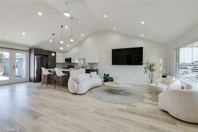 living area featuring french doors, recessed lighting, light wood-style flooring, high vaulted ceiling, and baseboards