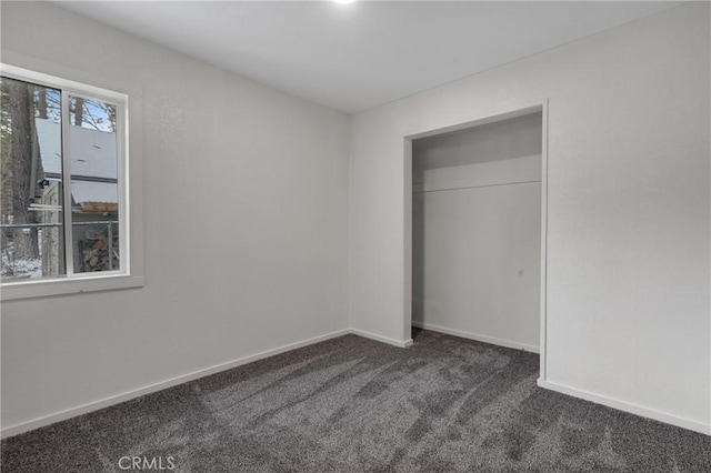 unfurnished bedroom with carpet floors and baseboards