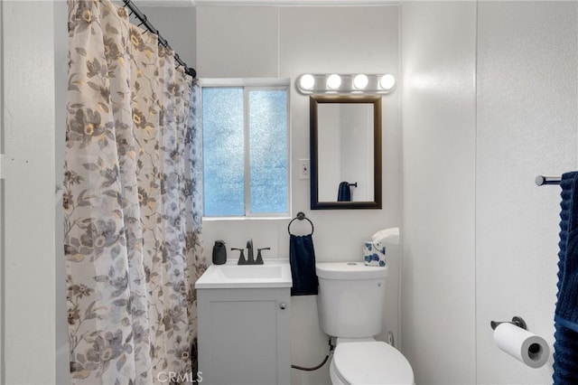 bathroom with vanity, toilet, and a shower with curtain