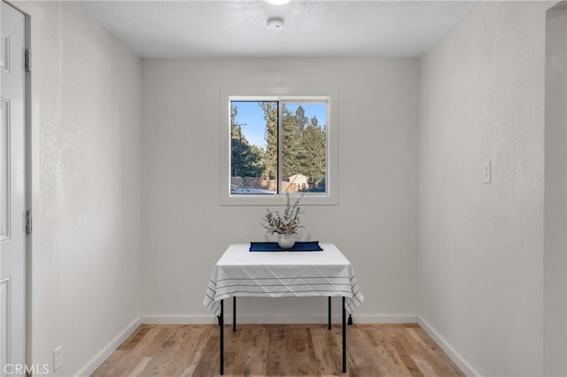 dining room with light wood-style floors and baseboards