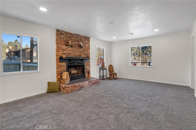 unfurnished living room featuring recessed lighting, carpet flooring, a fireplace, and baseboards