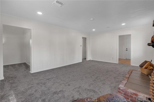 unfurnished living room featuring carpet floors, recessed lighting, visible vents, and baseboards