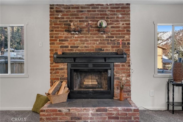 room details featuring carpet and a fireplace