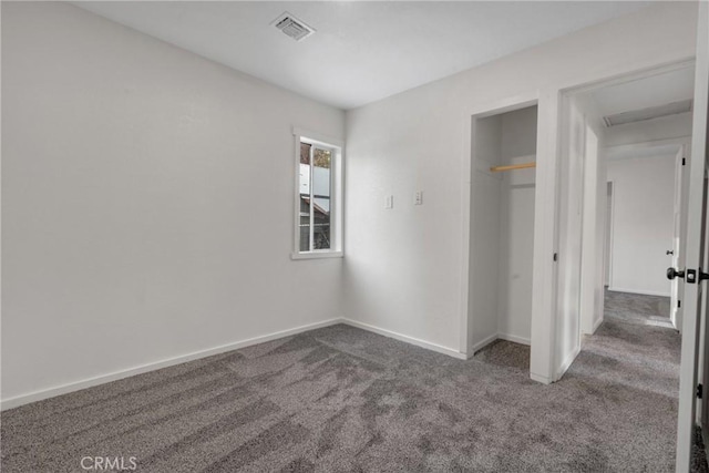 unfurnished bedroom with a closet, baseboards, visible vents, and carpet flooring