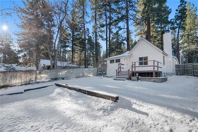 1131 Apple Ave, Wrightwood, CA 92397 - snow covered back of property featuring a chimney, a deck, and fence