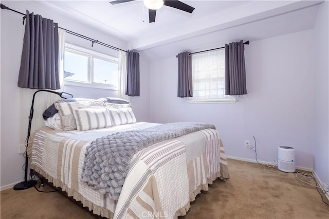 carpeted bedroom featuring lofted ceiling with beams, ceiling fan, and baseboards