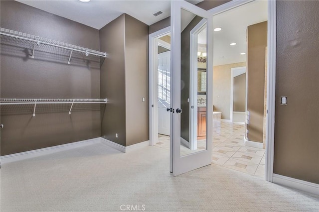 spacious closet with carpet floors and visible vents