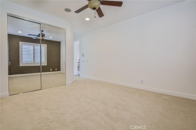 unfurnished bedroom with recessed lighting, carpet flooring, a ceiling fan, baseboards, and a closet