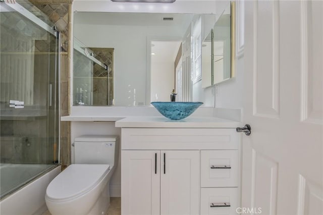 full bath with toilet, visible vents, combined bath / shower with glass door, and vanity