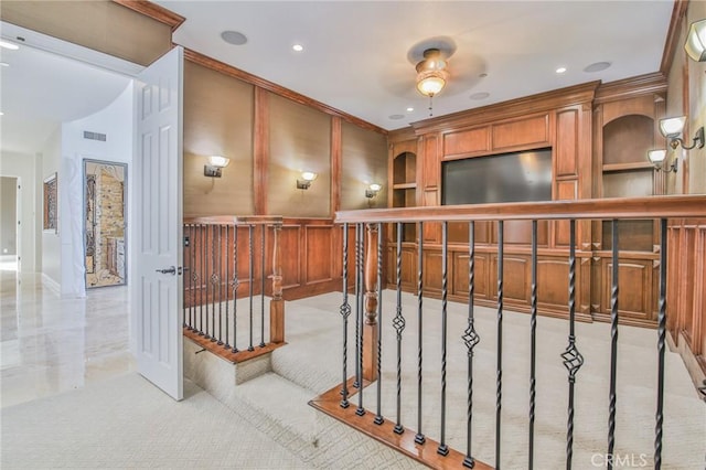 hall with visible vents, ornamental molding, and recessed lighting