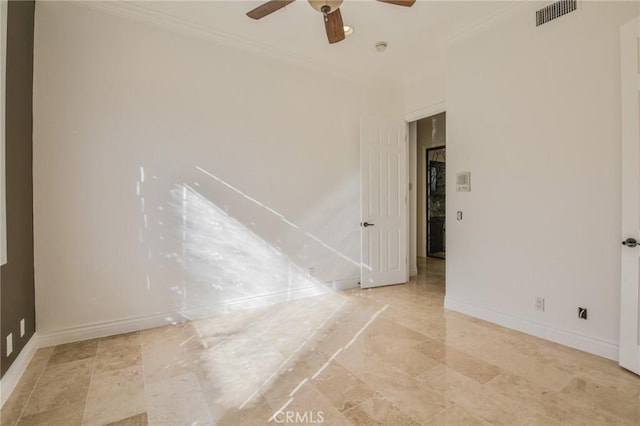 empty room with baseboards, ceiling fan, visible vents, and crown molding