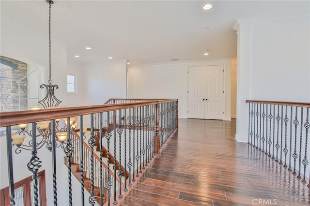 hall with baseboards, ornamental molding, wood finished floors, and recessed lighting