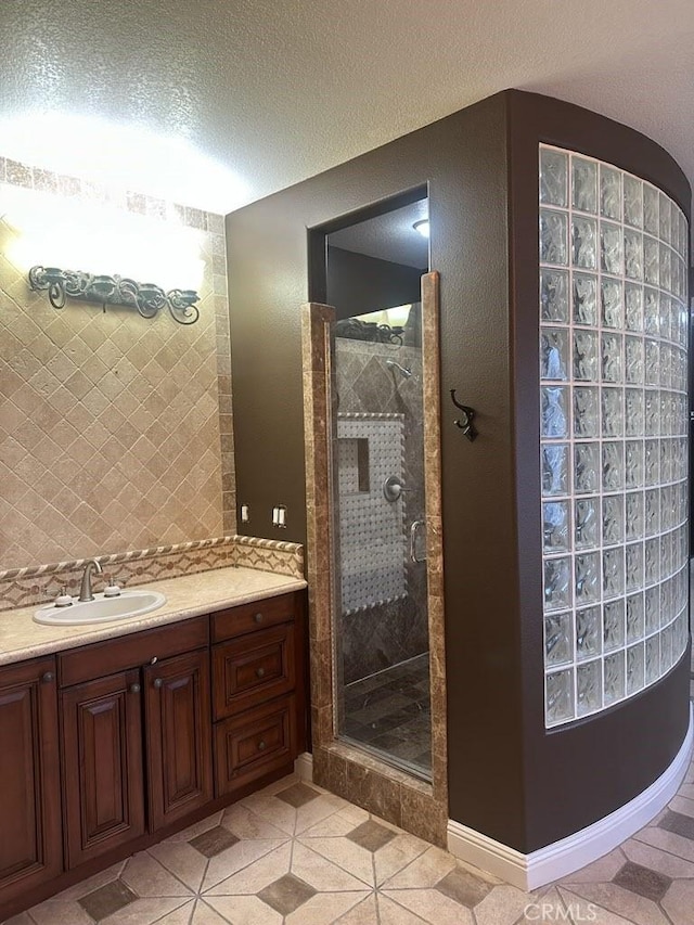 full bath with a stall shower, decorative backsplash, a textured ceiling, and tile patterned floors