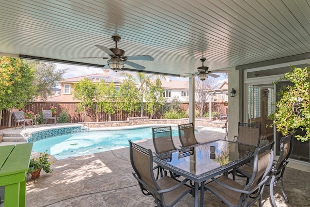 view of pool featuring outdoor dining area, fence, a ceiling fan, a fenced in pool, and a patio area