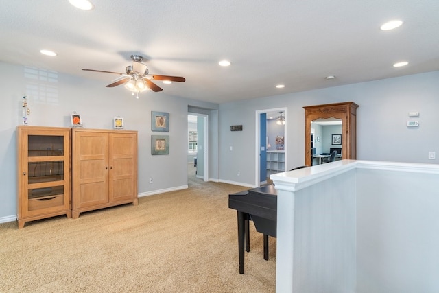 interior space with recessed lighting, baseboards, a ceiling fan, and light colored carpet