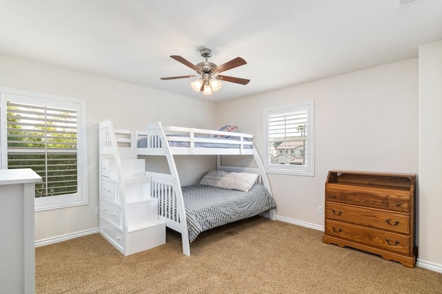 carpeted bedroom featuring a ceiling fan and baseboards