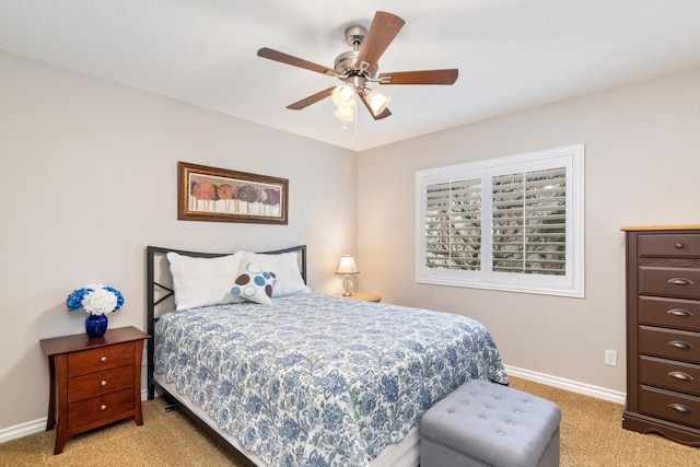 bedroom with light carpet, a ceiling fan, and baseboards