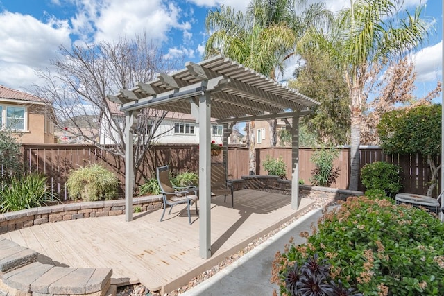 wooden deck with a fenced backyard and a pergola