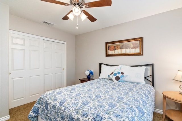 bedroom featuring carpet floors, ceiling fan, visible vents, and a closet