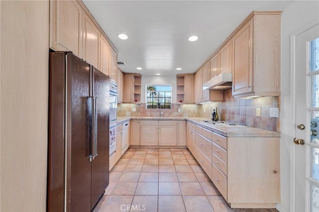 kitchen with open shelves, light countertops, light brown cabinets, white appliances, and under cabinet range hood