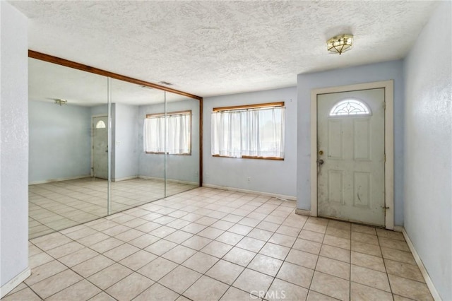 11671 Jacaranda Ave, Hesperia, CA 92345 - foyer entrance featuring baseboards, a textured ceiling, and light tile patterned floors