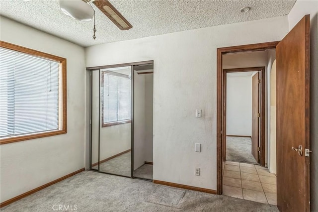 11671 Jacaranda Ave, Hesperia, CA 92345 - unfurnished bedroom featuring a textured ceiling, light colored carpet, multiple windows, and a closet