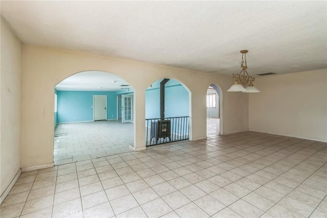 11671 Jacaranda Ave, Hesperia, CA 92345 - empty room with a textured ceiling, baseboards, visible vents, and light tile patterned floors