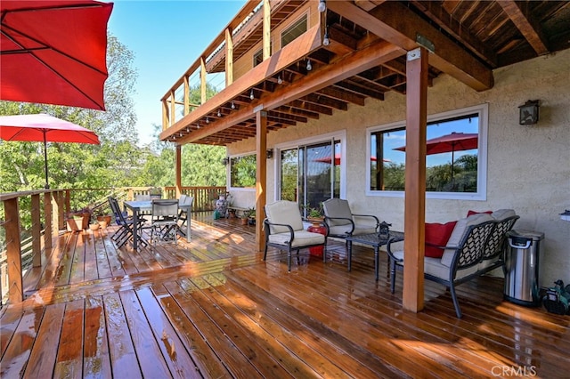 wooden terrace featuring outdoor dining area