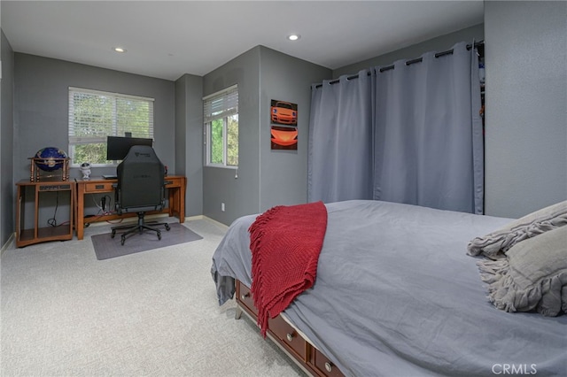 bedroom featuring light carpet, recessed lighting, and baseboards