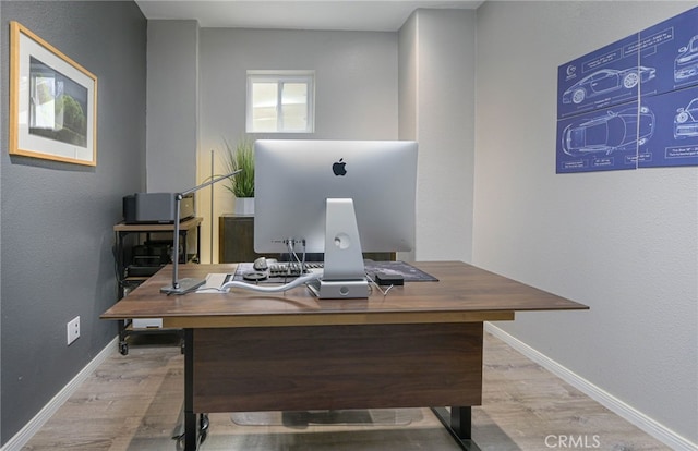 office space with baseboards and wood finished floors