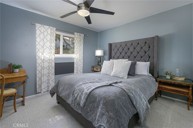 carpeted bedroom with a ceiling fan and baseboards