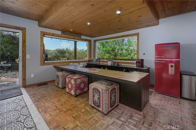 kitchen featuring wood ceiling, wood counters, visible vents, and a wealth of natural light