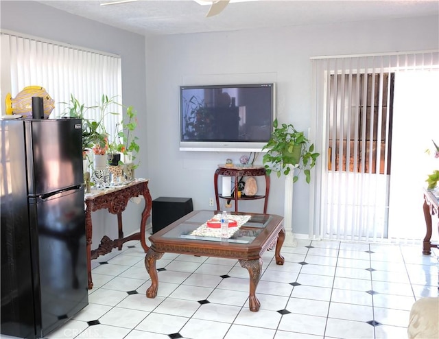 interior space with light tile patterned flooring and a ceiling fan