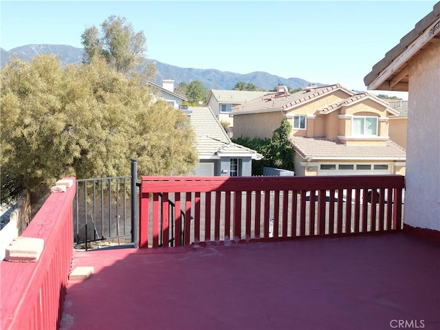 deck featuring a residential view and a mountain view