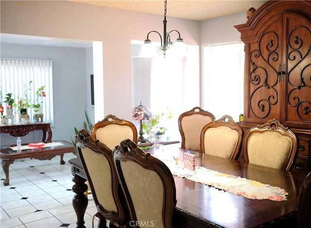 dining area featuring a textured ceiling and a notable chandelier