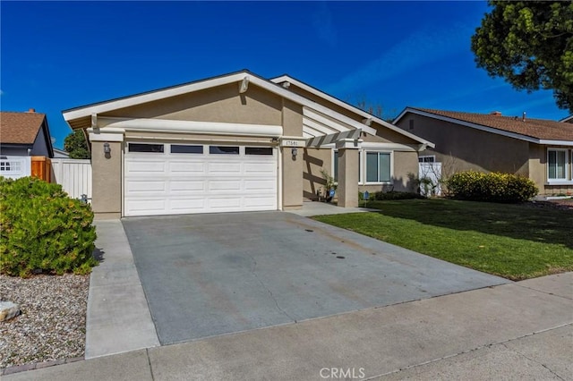 single story home with an attached garage, fence, concrete driveway, stucco siding, and a front lawn