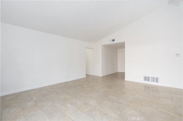 unfurnished room with high vaulted ceiling, baseboards, and visible vents