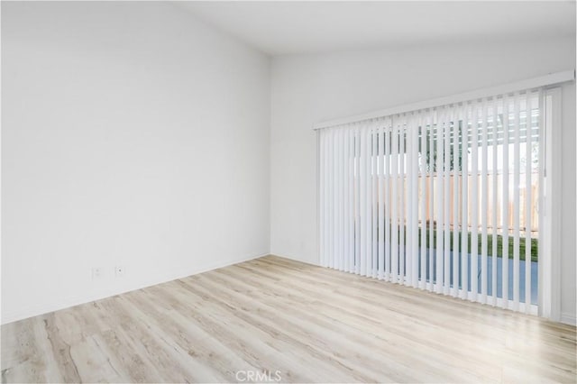 unfurnished room featuring vaulted ceiling and wood finished floors