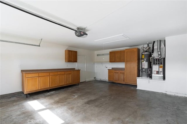 garage featuring heating unit, secured water heater, and a garage door opener