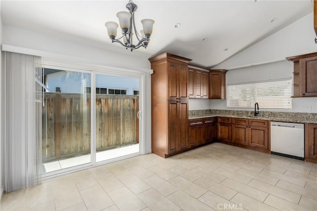 kitchen with decorative light fixtures, lofted ceiling, white dishwasher, a sink, and light stone countertops