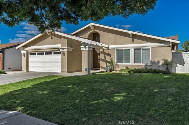 mid-century modern home with a garage, a front lawn, and stucco siding