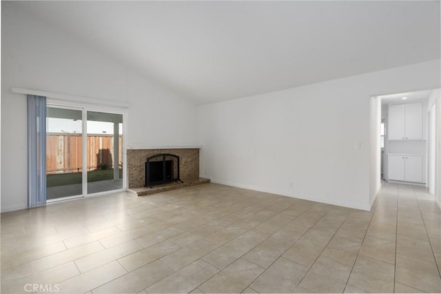 unfurnished living room with high vaulted ceiling, light tile patterned flooring, baseboards, and a premium fireplace